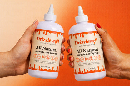 Drizzlewell zero sugar all purpose syrup held in hand, zero calorie and zero net carbs sweetener, keto friendly and diabetic friendly, perfect for coffee, cooking, baking, pancakes, cocktails and more